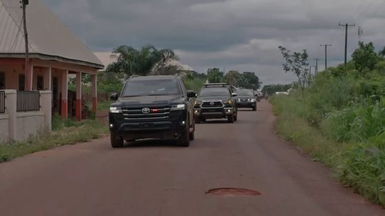 A small convoy of vehicles coming into a village in Benue State
