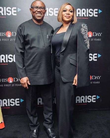 Peter Obi and his wife Margaret Obi in front of a ThisDay and Arise step-and-repeat banner